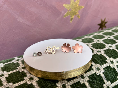 Samples of handcrafted post earrings from Alloy Atelier Workshop, showcasing various designs and finishes.